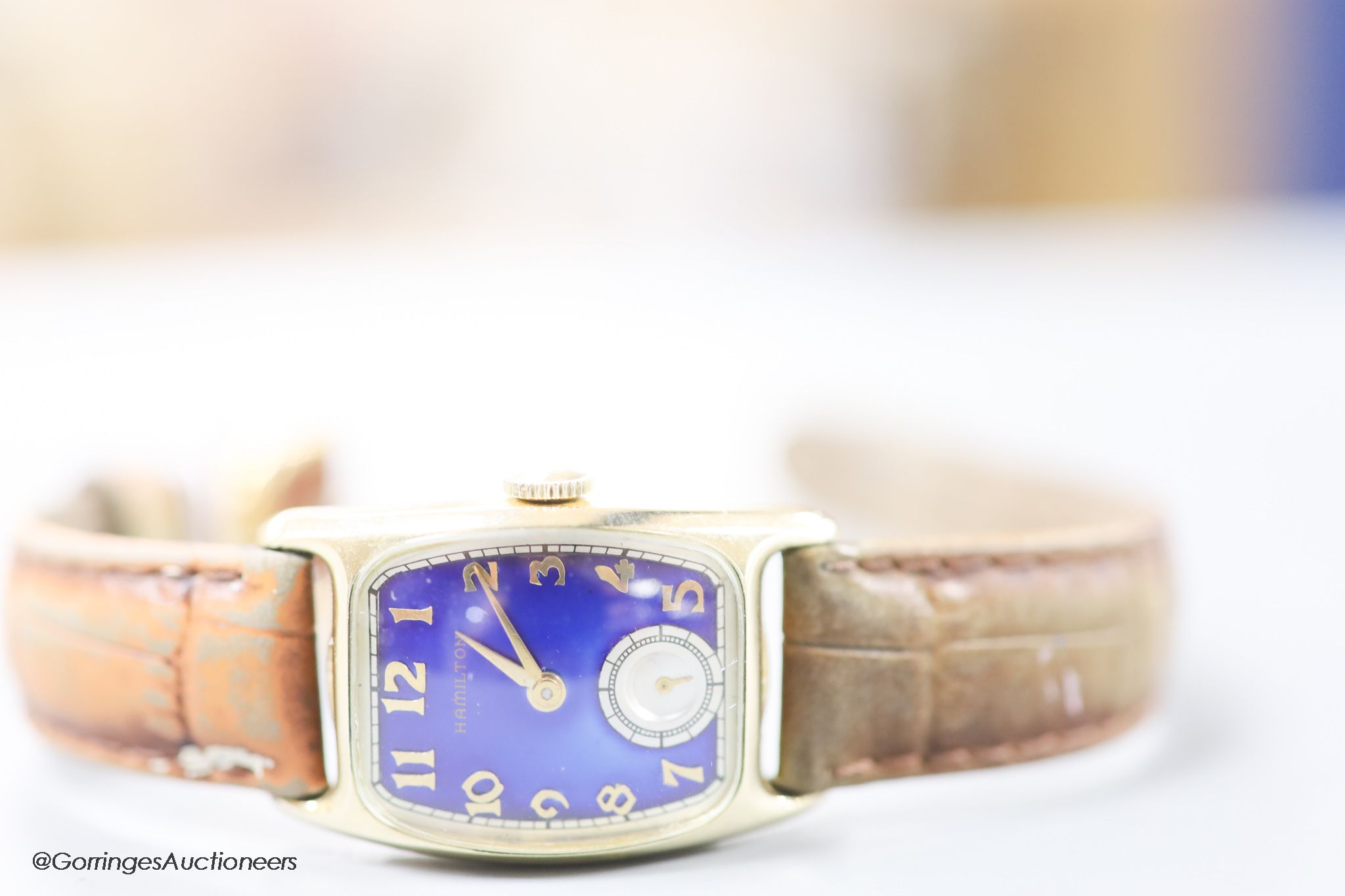 A gentleman's 1930's 14k gold filled Bulova manual wind wrist watch with blue enamel rectangular dial and subsidiary seconds, on a leather strap.